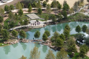 an overhead shot of people standing around the pond at Aggie Park