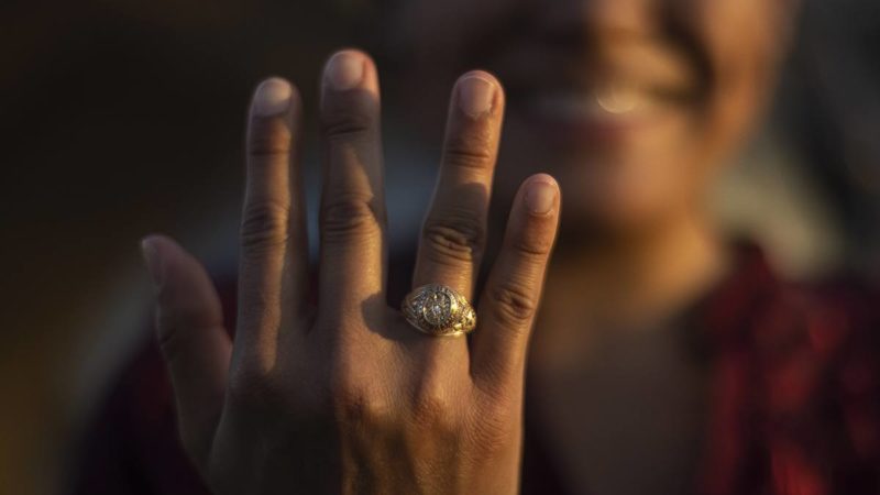 a woman showing her Aggie ring