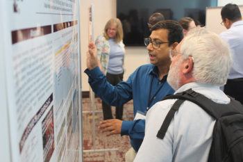 researchers discussing during a poster session