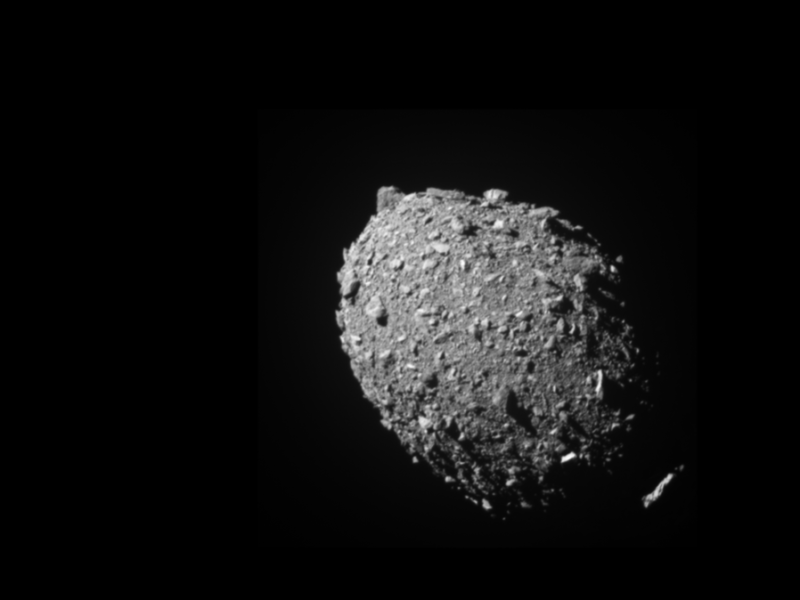 a photo of the rocky gray surface of an asteroid against the blackness of space