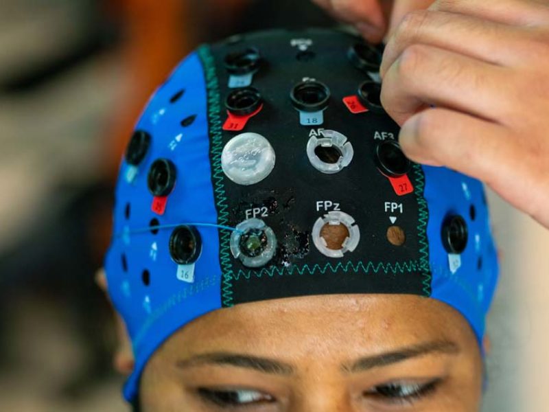 close-up of a woman wearing a track equipped with technology to capture brain activity