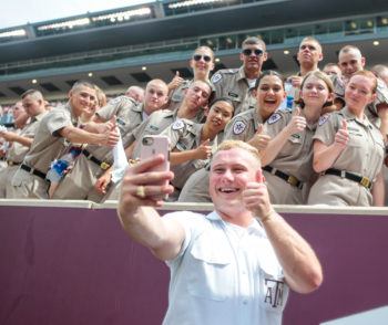 yell leader taking a selfie with cadets at Kyle Field