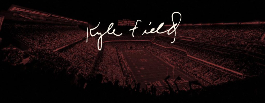 handwritten text that says "kyle field" over a background photo of the field