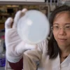 Portrait of chen in the lab holding up a petri dish