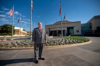 Warren Finch standing outside the Bush Library and Museum