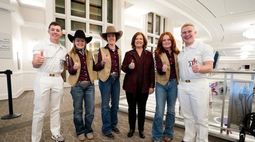 President M. Katherine Banks with rodeo participants and Yell Leaders