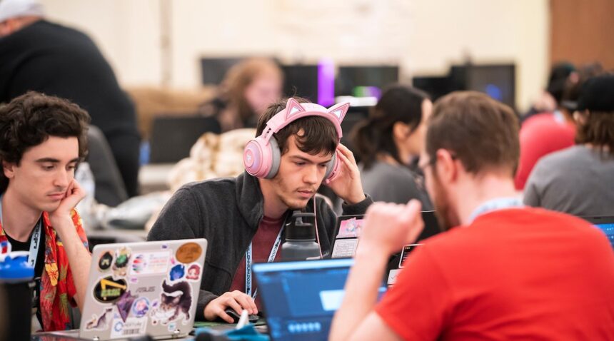 Three college students work on creating a game at the Chillennium game jam.