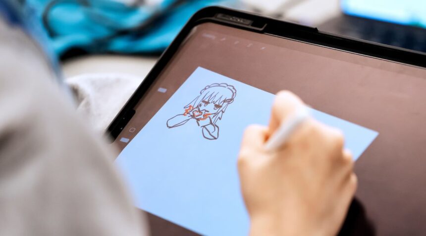 A college student works on drawing a character for a game at the Chillennium game jam.