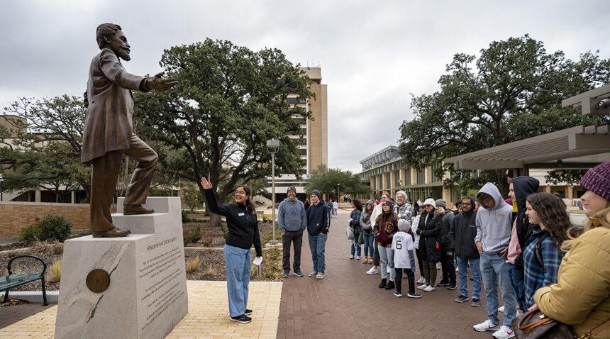 a tour group at the Matthew Gaines statue
