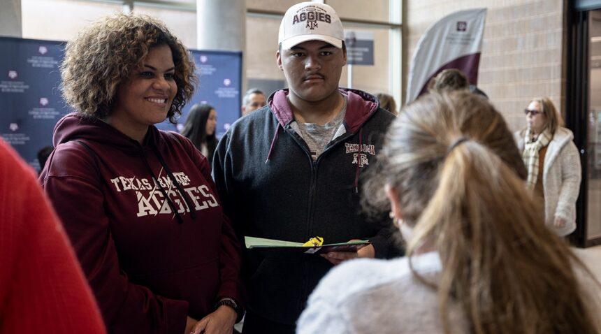 a prospective student and family members at Aggieland Saturday