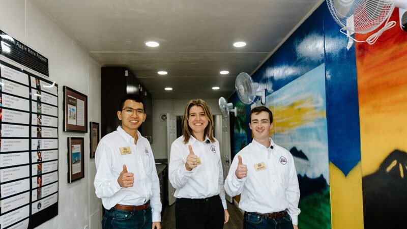 BUILD Chief Operating Officer Chase Parrish '24, Chief Financial Officer Albert Tran '24 and Chief Executive Officer Kate-Riley Rogers stand inside of the Ukraine TAMC