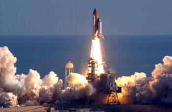 Space shuttle Columbia lifting up from launch pad
