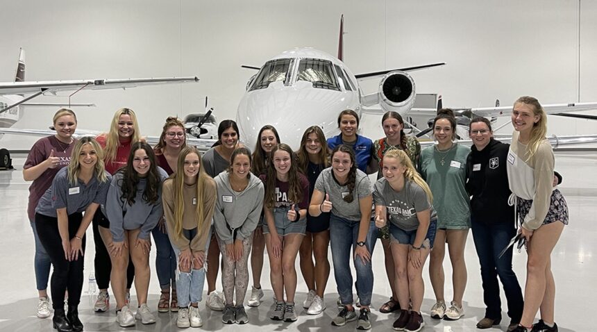 Texas A&M Women in Aviation in an airplane hangar