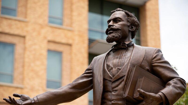 a photo of the Matthew Gaines statue with its arm outstretched