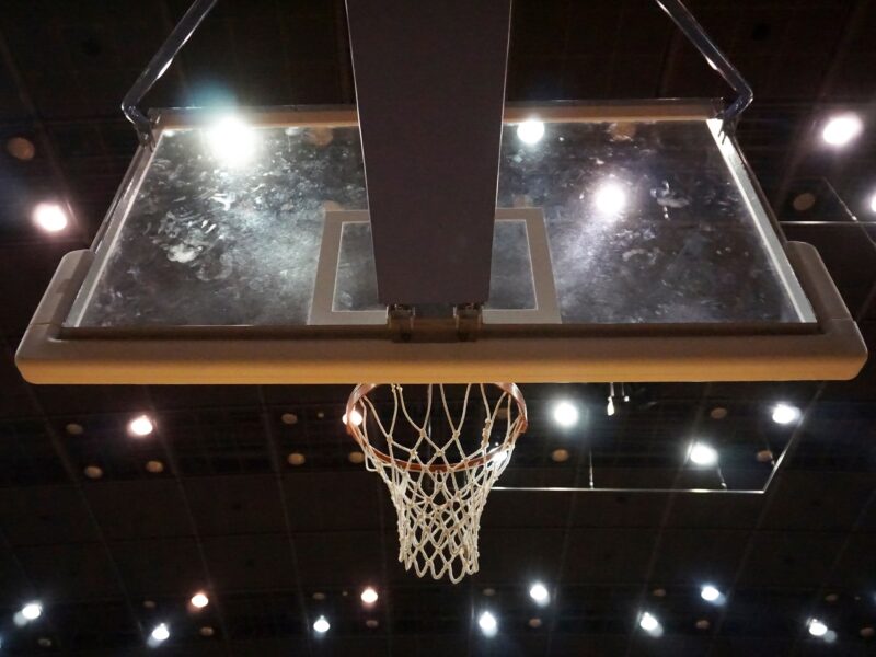Low angle view of back of basketball hoop in an illuminated stadium