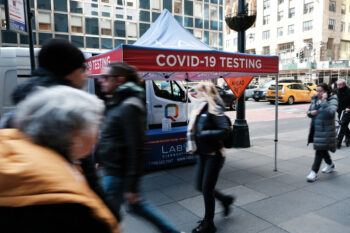 covid-19 testing tent on a busy sidewalk in manhattan