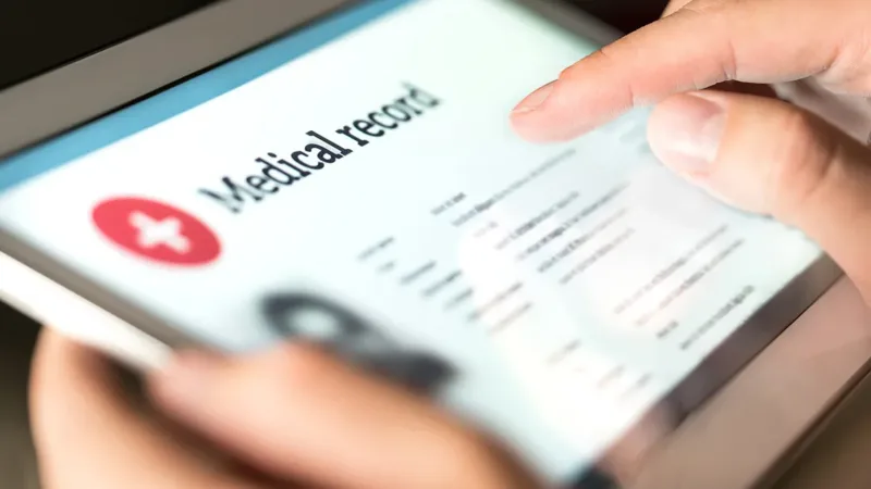 a person holding a screen that says medical records
