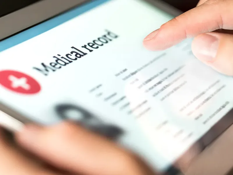 a person holding a screen that says medical records