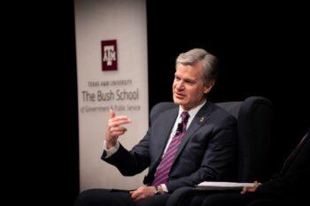 Christopher Wray seated on stage during talk