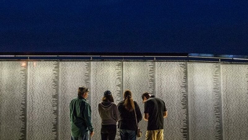 people standing before The Wall That Heals