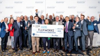FluxWorks poses with their giant check