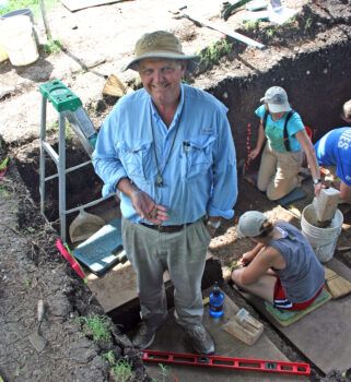 Dr. Waters holding a 15,000 year old projectile point uncovered at a dig in Texas