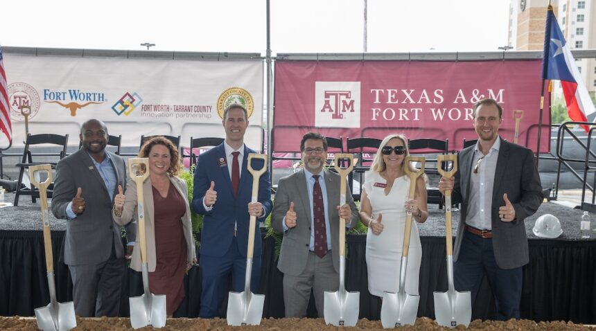 groundbreaking attendees posing with shovels