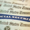 photo illustration of a Social Security Card alongside checks from the U.S. Treasury