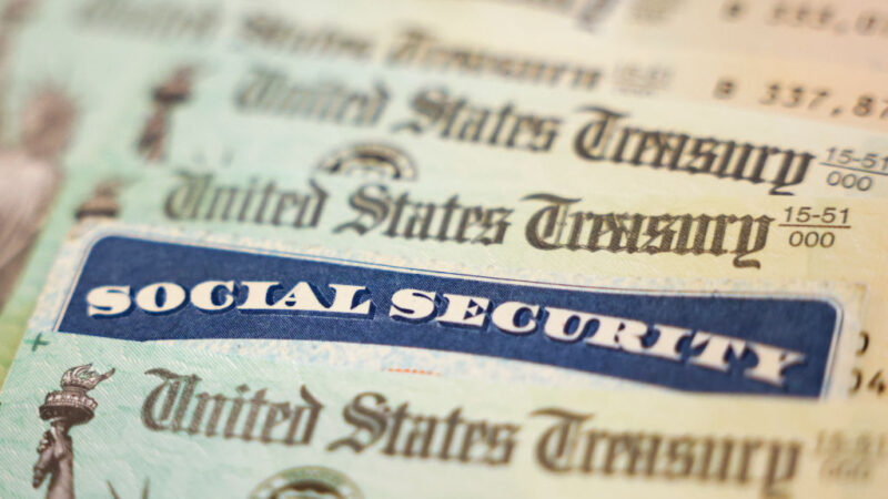 photo illustration of a Social Security Card alongside checks from the U.S. Treasury