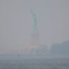 The Statue of Liberty is seen amid hazy conditions due to smoke from the Canadian wildfires on June 08, 2023