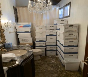 Boxes containing classified documents stacked in a bathroom