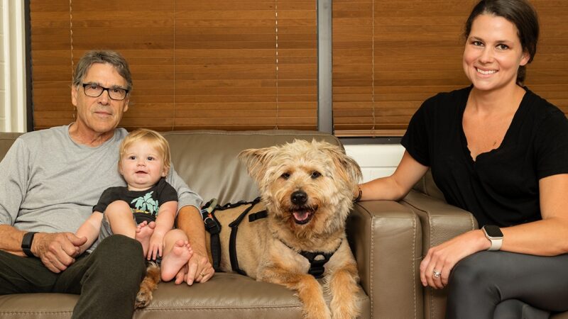 Rick Perry '72 with his grandson, Scout the dog, and Sydney Perry