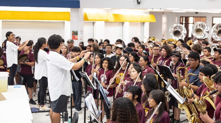a photo of a large group of young people playing instruments