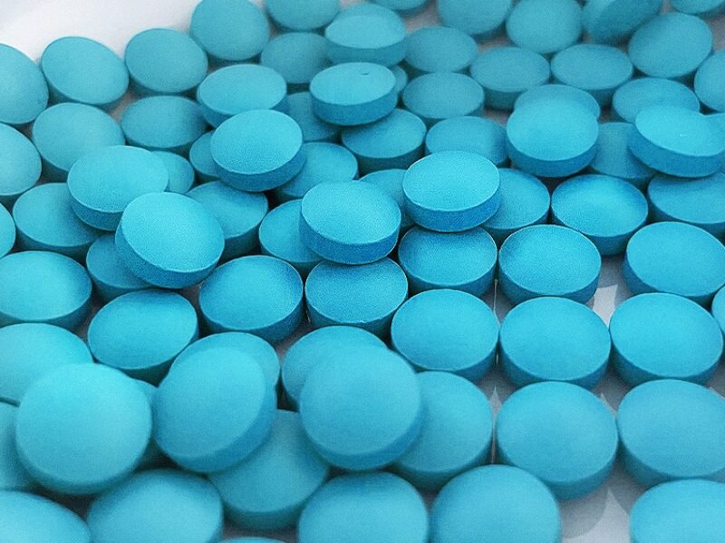Pile of blue medication tablets