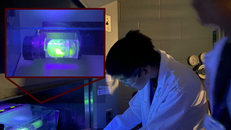 Students in Texas A&M's 2023 “Smash Chemistry” STEM camp use a luminescent polymer to study how forces are distributed in a mechanochemical reactor.