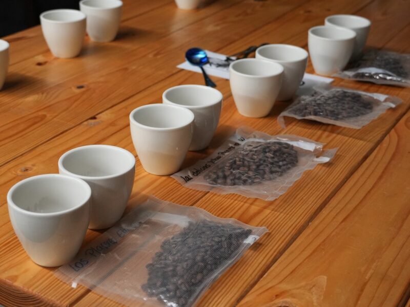 cups and coffee beans arranged on a table at the coffee center