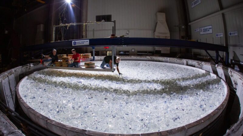 A piece of glass being placed into the mold for Mirror 7 for the Giant Magellan Telescope. The process of casting each of the project’s seven giant mirrors involves melting nearly 20 tons of glass in a spinning furnace, located beneath a football stadium in Tucson at the University of Arizona's Richard F. Caris Mirror Lab at Steward Observatory.