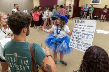 Aggie Transition Camp counselor Charlotte Shawver '23 welcomes incoming transfer students to the T-Camp sendoff from the Clayton W. Williams, Jr. Alumni Center on Aug. 6, 2021