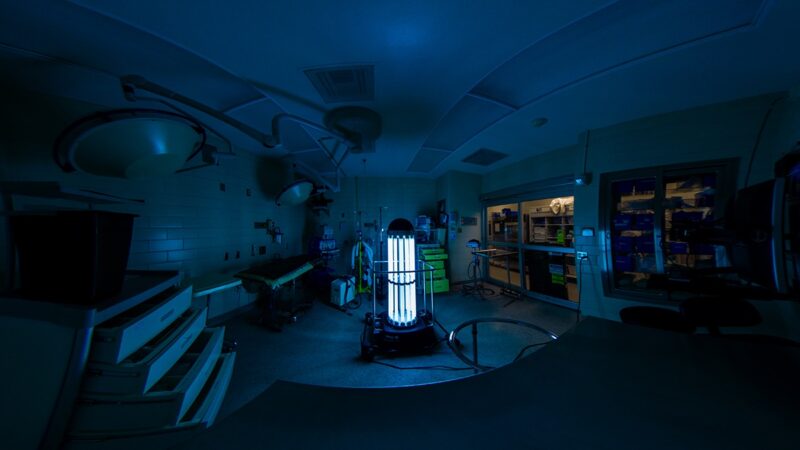 The Trudy robot lit up in a dark room at the vet school