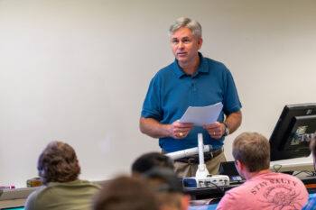 Russell McGee lectures students in a classroom.
