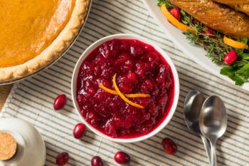 A bowl of cranberry sauce on a Thanksgiving table