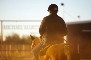 a photo of a man on horseback wearing a black riding helmet with a name tag that reads "Bob Byrns"