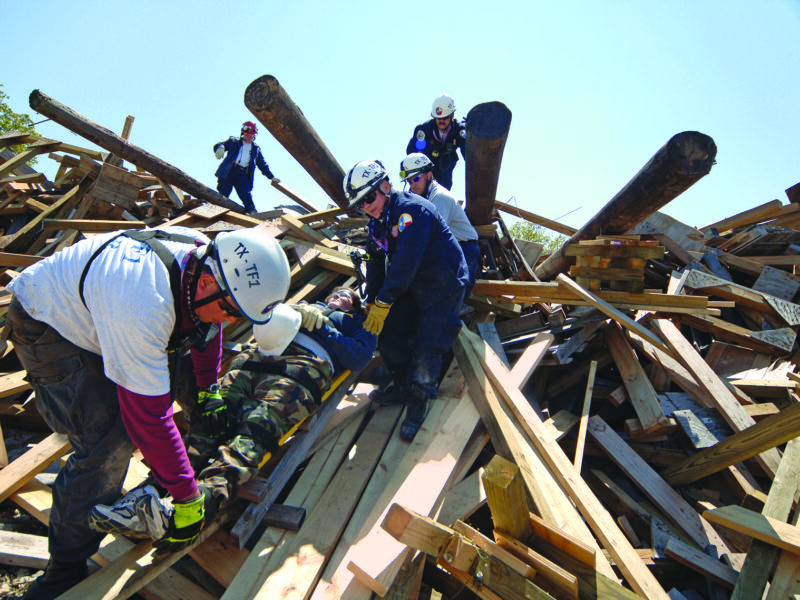 trainees in a simulated building collapse