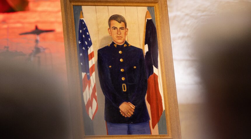 A photo of a painting of a U.S. Marine Corps veteran on display during a memorial service.