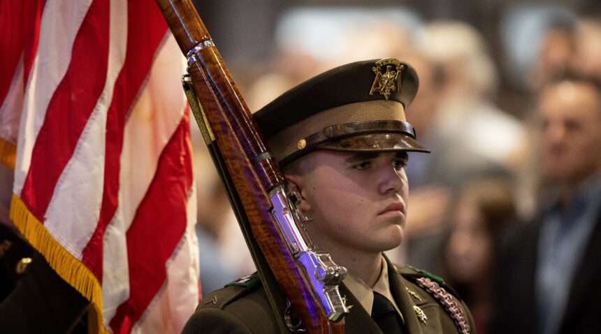 A photo of a Texas A&M University cadet with a rifle over his shoulder.