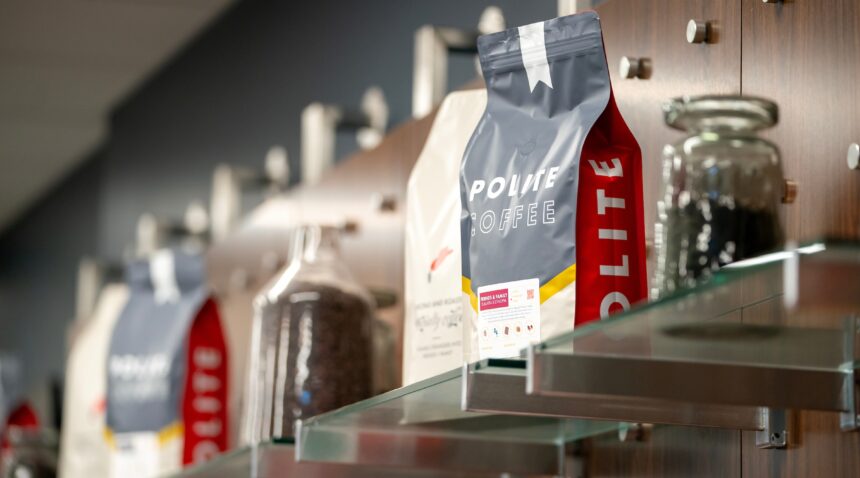 a photo of bags and jars of Polite Coffee Roasters beans sitting on a shelf