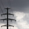 Power lines against a dark, cloudy sky