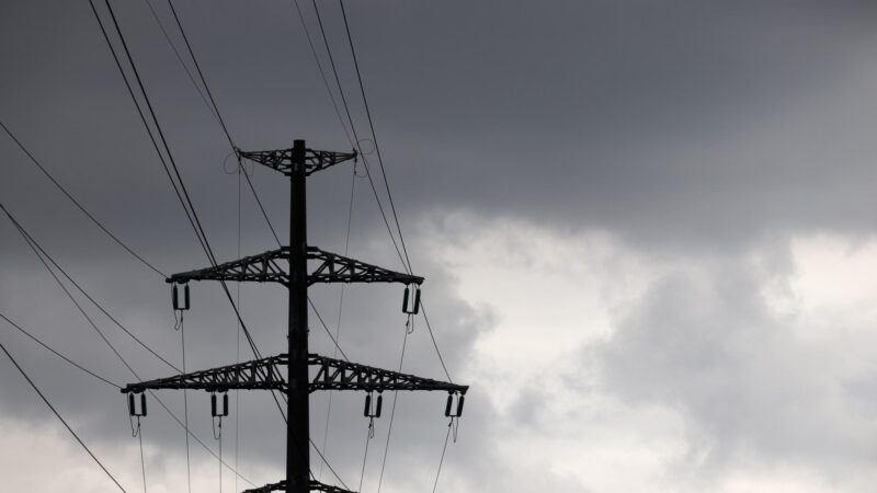 Power lines against a dark, cloudy sky