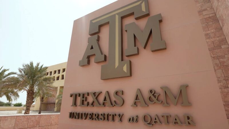 A photos of a sign at the Texas A&M University campus in Qatar.