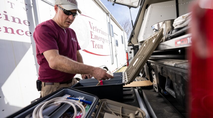 A photo of a member of the Veterinary Emergency Team setting up equipment.